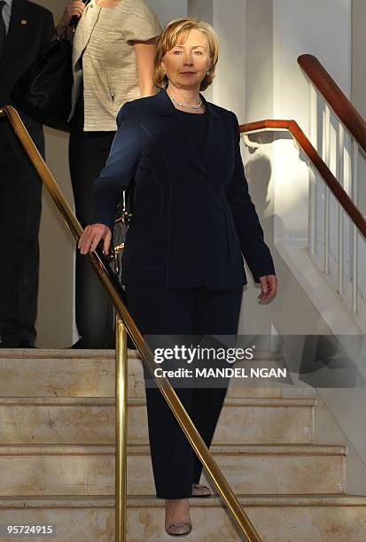 Secretary of State Hillary Clinton makes her way to greet Japan's Foreign Minister Katsuya Okada as he arrives for a bilateral meeting at a hotel in...