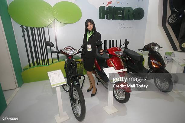 Model poses with bikes on display at a stall at the 10th Auto expo in New Delhi on Thursday, January 7, 2010.