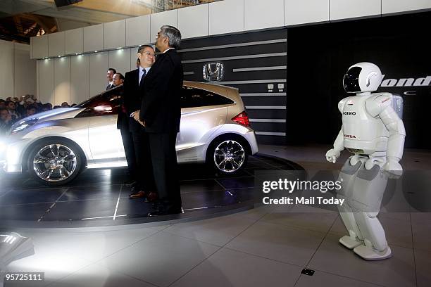 Honda officials with Asimo Robot at the launch of their small concept car of Honda at the 10th Auto expo in New Delhi on Thursday, January 7, 2010.