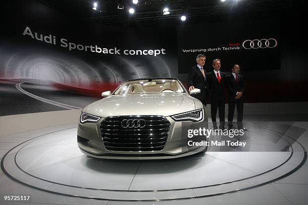 Audi officials with bollywood actor Rahul Bose pose next to a newly launched Audi car at the 10th Auto expo in New Delhi on Thursday, January 7, 2010.