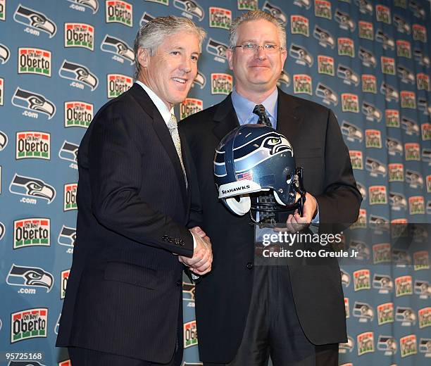 Tod Leiweke of the Seattle Seahawks presents new head coach Pete Carroll a Seahawks helmet during a press conference on January 12, 2010 at the...