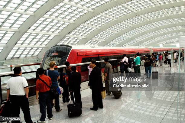 Passengers await a train at a platform of the subway station inside Terminal 3 of Beijing?s airport, China, 01 October 2008. The building was...