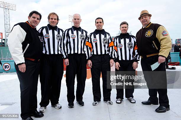 (Peter Laviolette coach of the Philadelphia Flyers and Claude Julien coach of the Boston Bruins pose with linesmen Lyle Seitz and Brian Murphy and...