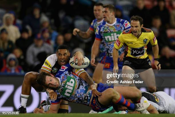 Lachlan Fitzgibbon of the Knights is tackled by the Panthers defence during the round 10 NRL match between the Newcastle Knights and the Penrith...