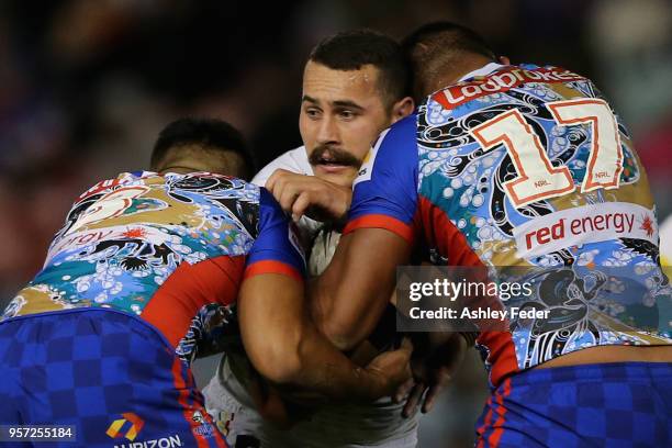 Reagan Campbell-Gillard of the Panthers is tackled by the Knights defence during the round 10 NRL match between the Newcastle Knights and the Penrith...