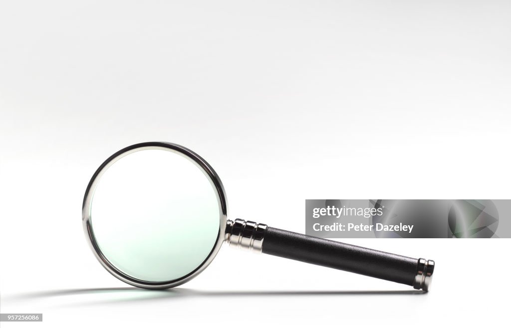 MAGNIFYING GLASS ON WHITE