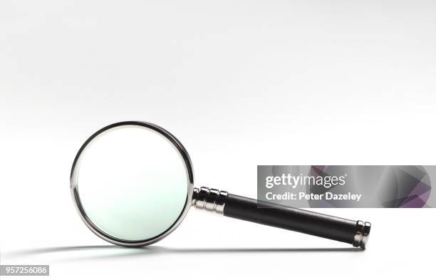magnifying glass on white - vergrößerungsglas stock-fotos und bilder