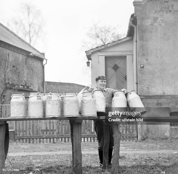 Ein Mitarbeiter der LPG Schwante stellt leere Milchkannen zur Abholung bereit, aufgenommen im Oktober 1970.