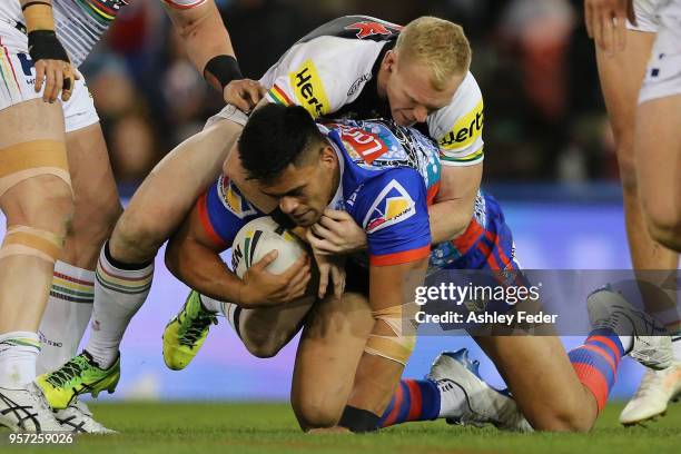 Herman Ese'ese of the Knigths is tackled by the Panthers defence during the round 10 NRL match between the Newcastle Knights and the Penrith Panthers...