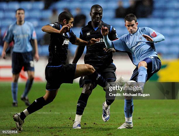 Michael McIndoe of Coventry is challenged by Hayden Mullins of Portsmouth during the FA Cup sponsored by E.ON 3rd round replay match between Coventry...