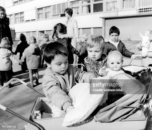 Kinder spielen mit Puppen und Kinderwagen auf dem Gelände einer der zahlreichen Kindergärten, aufgenommen 1979 im Stadtteil Prohlis in Dresden. In...