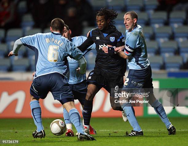Frederick Piquionne of Portsmouth competes against Stephen Wright and James McPake of Coventry City during the FA Cup sponsored by E.ON 3rd Round...