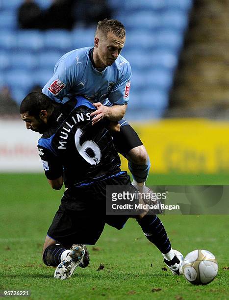 Sammy Clingan of Coventry is challenged by Hayden Mullins of Portsmouth during the FA Cup sponsored by E.ON 3rd round replay match between Coventry...