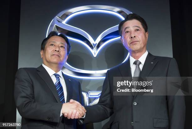 Akira Marumoto, incoming chief executive officer of Mazda Motor Corp., left, and Masamichi Kogai, outgoing president and chief executive officer,...