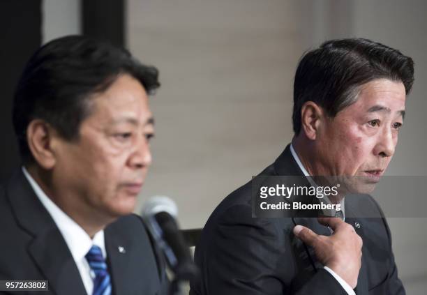 Akira Marumoto, incoming chief executive officer of Mazda Motor Corp., left, listens as Masamichi Kogai, outgoing president and chief executive...