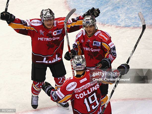 Rob Collins of DEG Metro Stars celebrates his first goal with Daniel Kreutzer and Patrick Reimer during the DEL match between DEG Metro Stars and ERC...