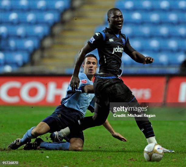 Papa Bouba Diop of Portsmouth is tackled by Richard Wood of Coventry during the FA Cup sponsored by E.ON 3rd round replay match between Coventry City...