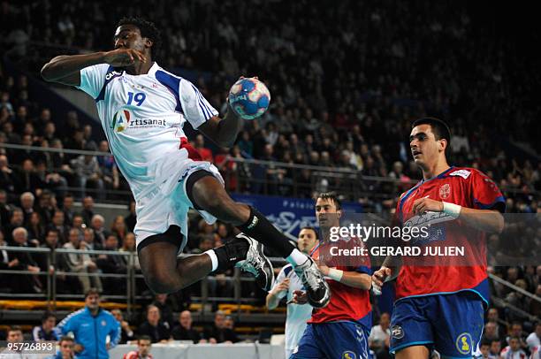 French Daouda Karaboue tries to score eyed by Serbian Momir Ilic and Zarko Sesum during the handball friendly match France vs. Serbia, on January 12,...