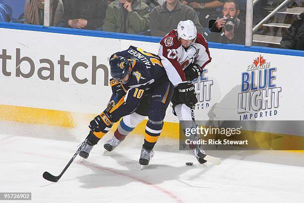 Henrik Tallinder of the Buffalo Sabres fights for the puck against Milan Hejduk of the Colorado Avalanche at HSBC Arena on January 9, 2010 in...