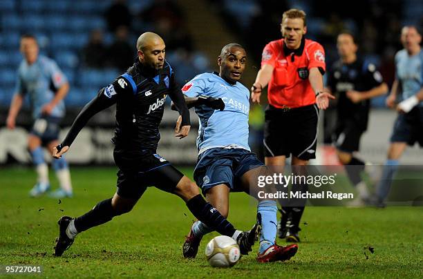 Clinton Morrison of Coventry passes the ball under pressure from Anthony Vanden-Borre of Portsmouth during the FA Cup sponsored by E.ON 3rd round...