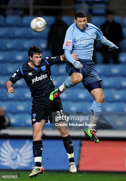 Leon Best of Coventry heads the ball past Marc Wilson of Portsmouth during the FA Cup sponsored by E.ON 3rd round replay match between Coventry City...
