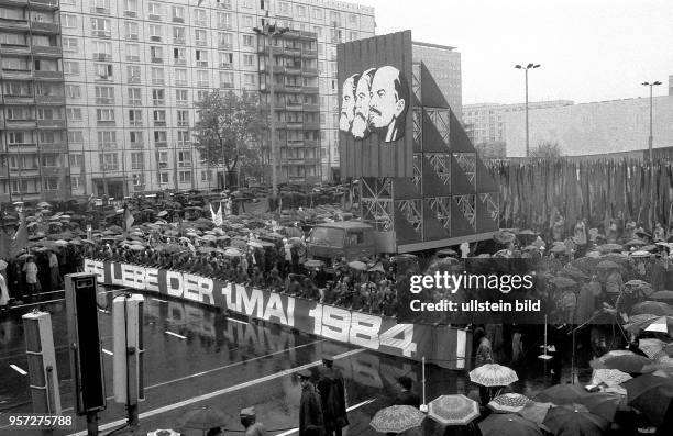 Die Bildnisse von Marx, Engels und Lenin werden hinter einem Spruchband "Es Lebe der 1. Mai 1984" auf der Demonstration zum 1. Mai auf der...