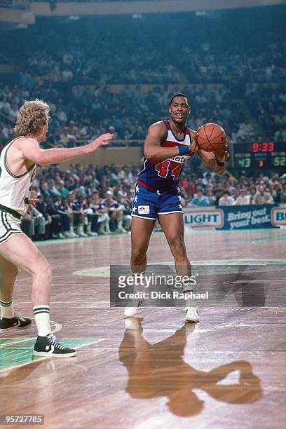 Rick Mahorn of the Washington Bullets passes against Larry Bird of the Boston Celtics during a game played in 1984 at the Boston Garden in Boston,...