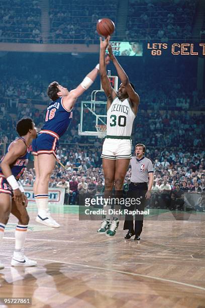 Carr of the Boston Celtics shoots a jump shot against Ernie Grunfeld of the New York Knicks during a game played in 1984 at the Boston Garden in...