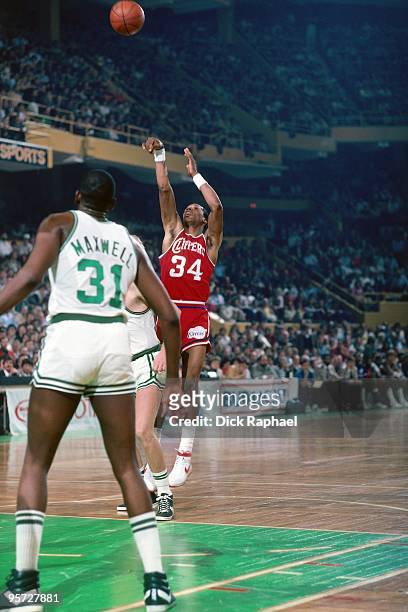 Terry Cummings of the San Diego Clippers shoots a jump shot against Cedric Maxwell of the Boston Celtics during a game played in 1984 at the Boston...