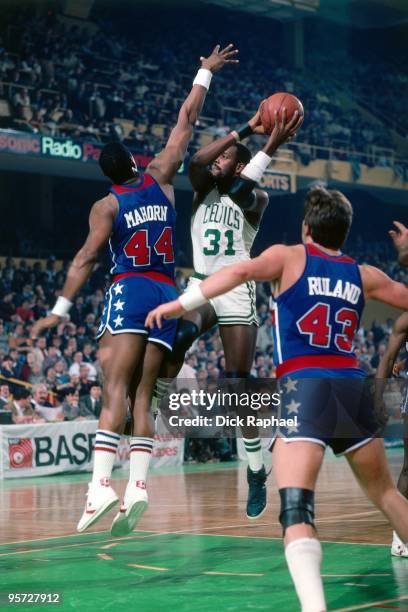 Cedric Maxwell of the Boston Celtics goes up for a shot against Rick Mahorn of the Washington Bullets during a game played in 1984 at the Boston...