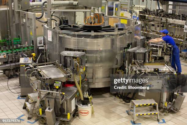 Worker checks an automated labeling machine at the Baltika Breweries LLC plant, operated by Carlsberg A/S, in Saint Petersburg, Russia, on Thursday,...