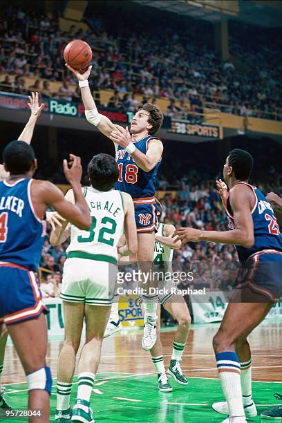 Ernie Grunfeld of the New York Knicks goes up for a shot against Kevin McHale of the Boston Celtics during a game played in 1984 at the Boston Garden...