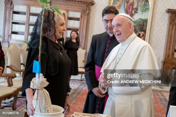 Pope Francis exchanges gifts with Romania's Prime Minister Viorica Dancila during a private audience in the pontiff's studio at the Vatican on May...