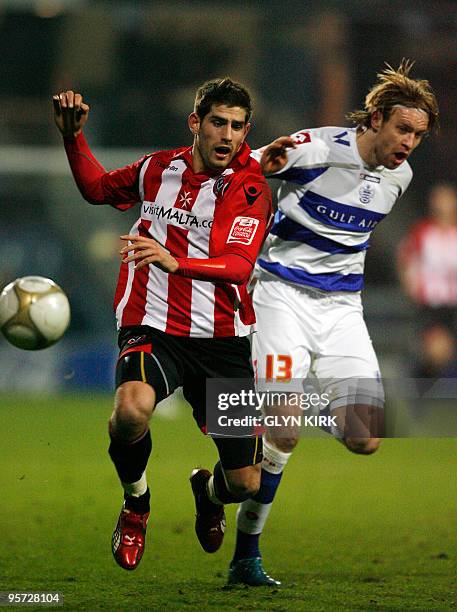 Sheffield United's Welsh striker Ched Evans vies with Queens Park Rangers' Latvian defender Kaspars Gorkss during their FA Cup third round replay...