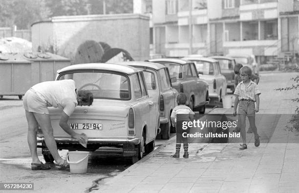 Ein Familienvater wäscht im Neubaugebiet Helbraer Straße in der Lutherstadt Eisleben seinen Pkw - einen Trabant, aufgenommen am . Seine drei...