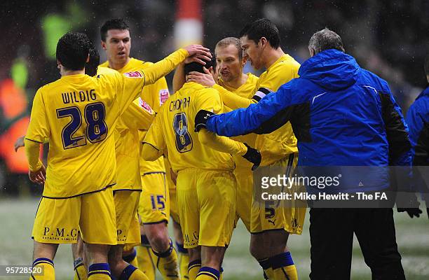 Michael Chopra of Cardiff is congratulated by team mates and manager David Jones after scoring during the FA Cup 3rd Round match between Bristol City...
