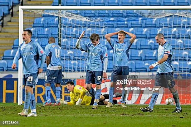 Dejected Coventry players react after conceding the match winning goal with only seconds to play in the second period of extra time during the FA Cup...