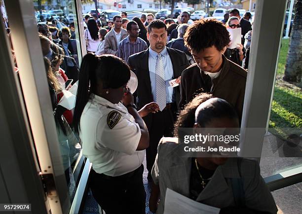 People file into the Village at Gulfstream Park job fair on January 12, 2010 in Hallandale, Florida. The shopping center, which is a new addition to...