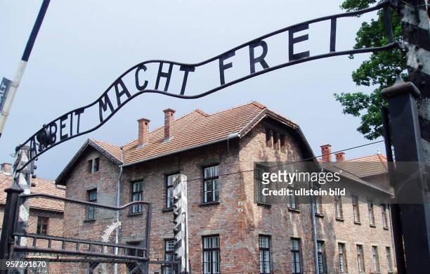 Außenansicht des Eingangsbereichs zum nationalsozialistischen Konzentrationslager Auschwitz-Birkenau mit der Inschrift "Arbeit macht frei" über dem...