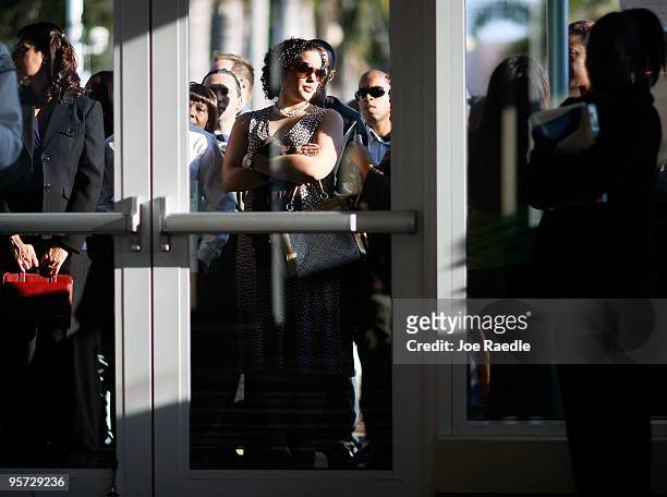 People wait for their numbers to be called to enter the Village at Gulfstream Park job fair on January 12, 2010 in Hallandale, Florida. The shopping...