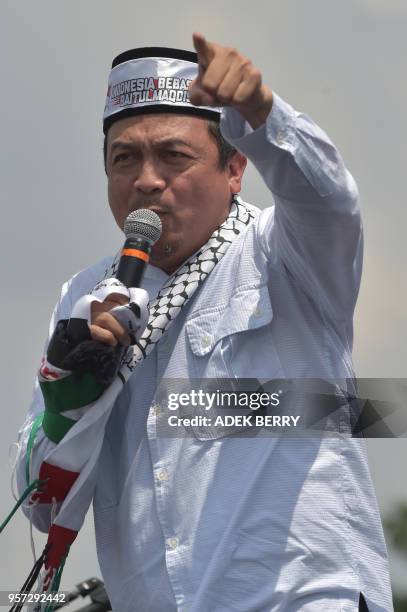 Indonesian preacer Bachtiar Nasir gestures while delivering his speech during congregational Friday prayers as part of a rally at the National...