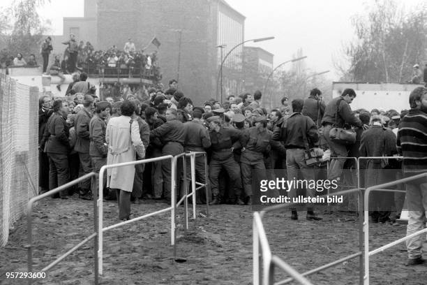 Soldaten der Grenztruppen der DDR versuchen den Ansturm der Massen am provisorisch eingerichteten Grenzübergang am Potsdamer Platz in geordnete...