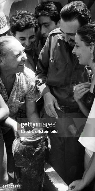 Cuban leader Fidel Castro talking to fishermen in Playa de Giron who made a good catch that day - 1962