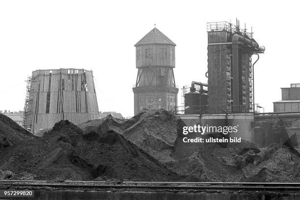 Blick über das Kohlelager, dahinter Abkühlturm; Wasserturm und Gasreinigungsanlage, aufgenommen 1980 im Gaswerk an der Dimitroffstraße/Ecke...