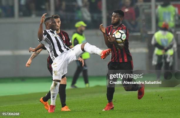 Kwadwo Asamoah of Juventus competes for the ball whit Franck Yannick Kessie of AC Milan during the TIM Cup Final between Juventus and AC Milan at...