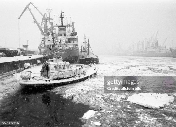 Rostock / Seehafen / Umschlag / Winter / Eis / 1985 / Reisezugwagen fuer Afrika / Lotensboot "Wels" im Eis. Es brachte den Lotsen an Bord des...