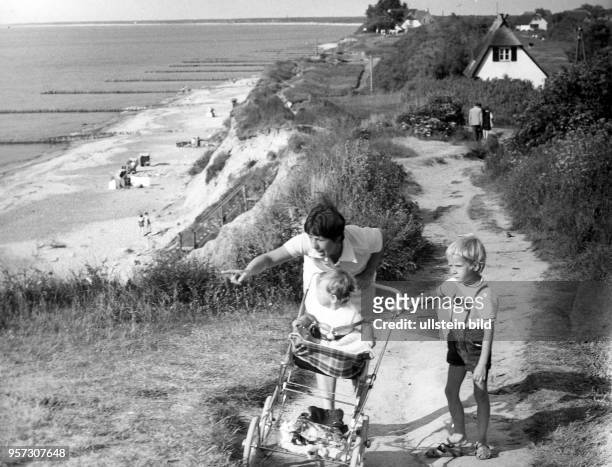 Eine Mutter mit ihren beiden Kindern bei einem Spaziergang an der Ostseeküste in Ahrenshoop, aufgenommen im Juni 1973. Die Ostsee war in der DDR...