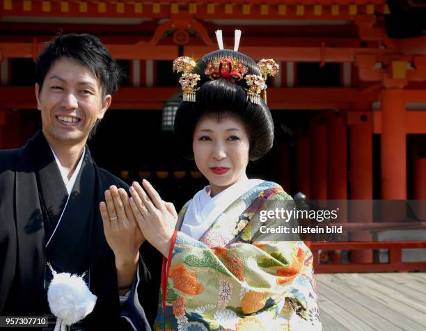 Oktober 2009 / Japan / Insel Miyajima / Anläßlich einer Hochzeit tragen das Brautpaar beim Besuch des Isukushima-Schrein auf der Insel Miyajima...