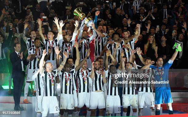 Juventus players celebrate with the trophy after winning the TIM Cup Final between Juventus and AC Milan at Stadio Olimpico on May 9, 2018 in Rome,...