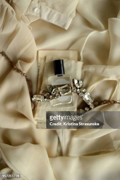 perfume bottle and a necklace - choosing perfume stock pictures, royalty-free photos & images
